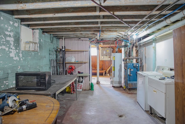 below grade area featuring independent washer and dryer, gas water heater, and a heating unit