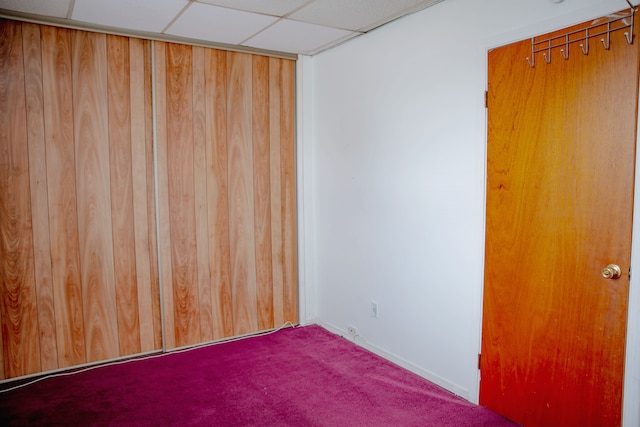 empty room featuring carpet and baseboards