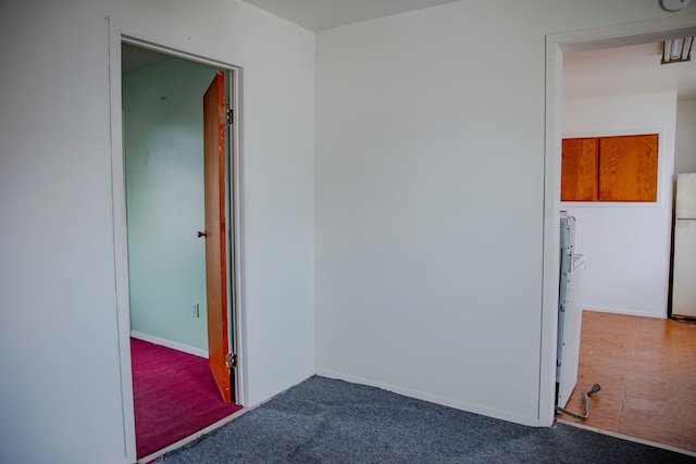 unfurnished room with carpet floors and baseboards