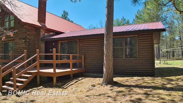 940 Wood River Rd, Grayling, MI 49738 - back of house with a wooden deck, metal roof, and a chimney