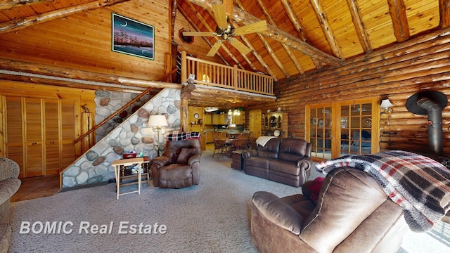 940 Wood River Rd, Grayling, MI 49738 - carpeted living room with high vaulted ceiling, wooden ceiling, french doors, beam ceiling, and rustic walls