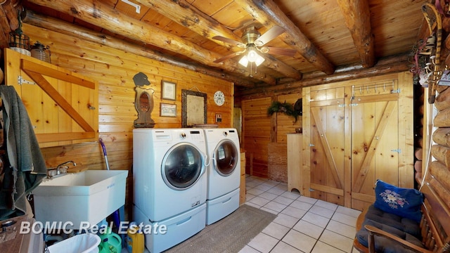 940 Wood River Rd, Grayling, MI 49738 - laundry area featuring washing machine and dryer, wood ceiling, light tile patterned flooring, a ceiling fan, and wood walls
