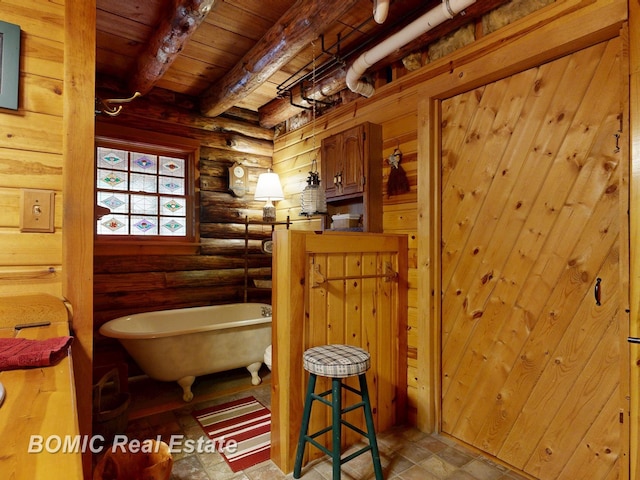 940 Wood River Rd, Grayling, MI 49738 - full bath with beamed ceiling, wood ceiling, a freestanding tub, and rustic walls