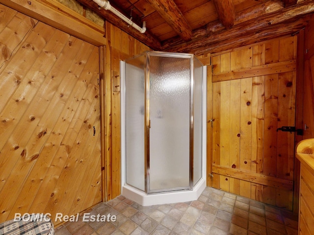 940 Wood River Rd, Grayling, MI 49738 - bathroom with beam ceiling, a stall shower, wooden walls, and wood ceiling