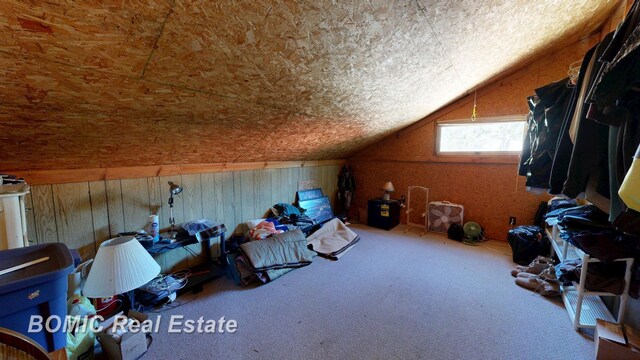 940 Wood River Rd, Grayling, MI 49738 - bonus room featuring lofted ceiling, carpet, and wood walls