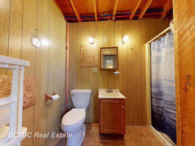 940 Wood River Rd, Grayling, MI 49738 - full bathroom featuring wooden walls, a shower with shower curtain, vanity, and toilet