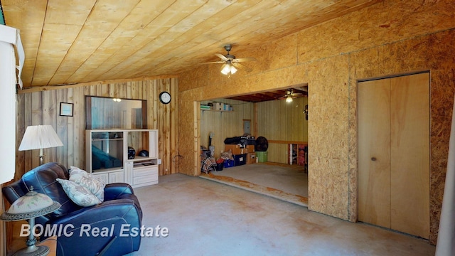 940 Wood River Rd, Grayling, MI 49738 - living area featuring a ceiling fan, concrete floors, wood ceiling, and wood walls