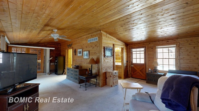 940 Wood River Rd, Grayling, MI 49738 - carpeted living area with wood ceiling, ceiling fan, wood walls, and vaulted ceiling