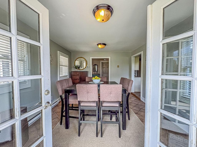 dining area with baseboard heating, baseboards, and french doors
