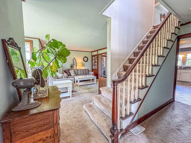 staircase featuring carpet flooring and baseboards