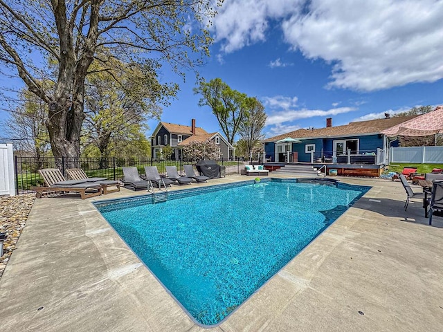 view of pool featuring a patio area and fence