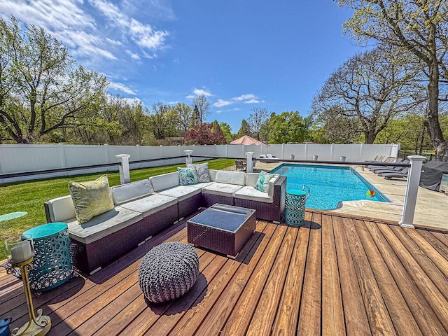view of swimming pool with outdoor lounge area, a deck, and a fenced backyard