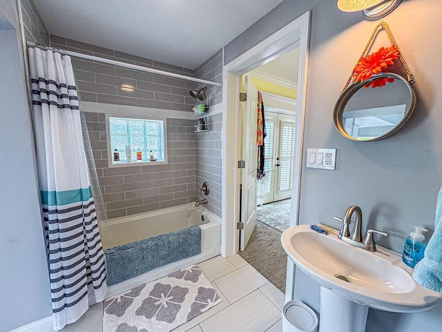 full bathroom with plenty of natural light, shower / bathtub combination with curtain, and a sink
