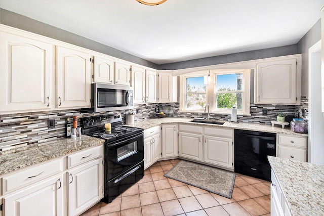 kitchen with black appliances, a sink, and backsplash
