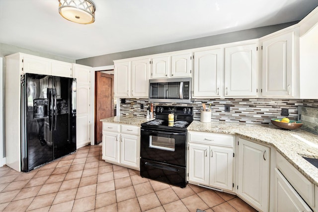 kitchen featuring black appliances, tasteful backsplash, white cabinetry, and light tile patterned floors