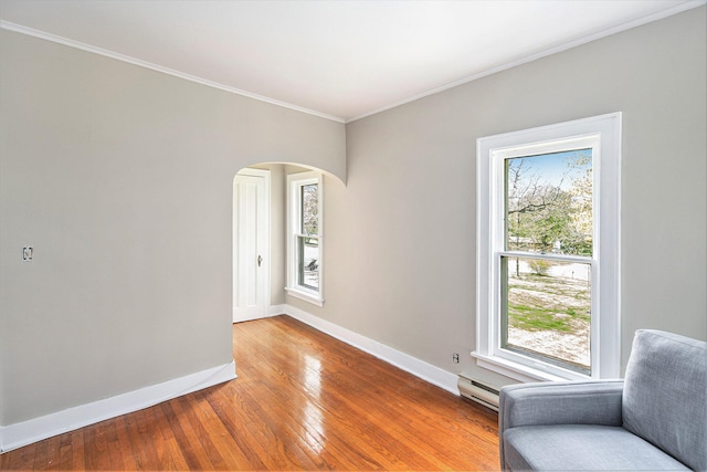 living area with baseboards, light wood-style flooring, arched walkways, ornamental molding, and baseboard heating