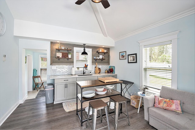 dining space featuring dark wood-style floors, a ceiling fan, baseboards, and ornamental molding