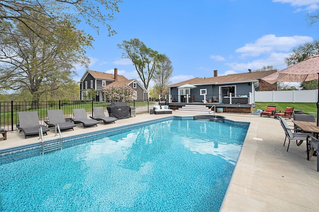 view of swimming pool featuring a deck, a fenced backyard, a patio area, and area for grilling