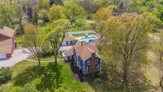 aerial view of property and surrounding area featuring a pool area