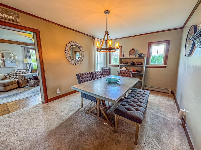 dining space with baseboard heating, a chandelier, carpet flooring, baseboards, and crown molding