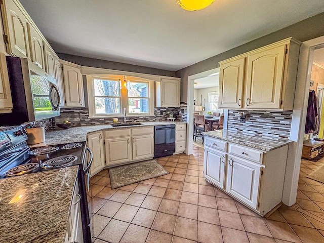 kitchen with electric range oven, black dishwasher, a sink, tasteful backsplash, and stainless steel microwave