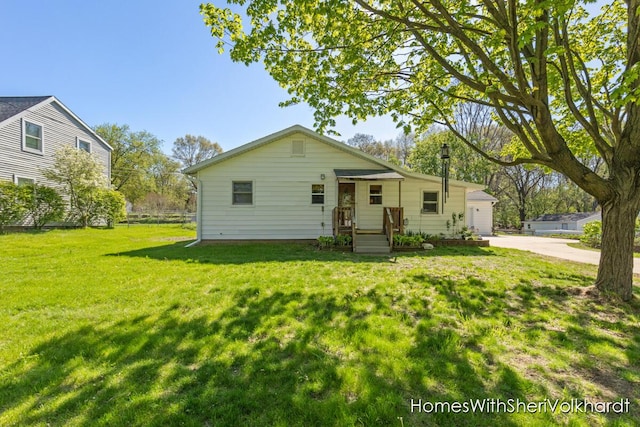 bungalow-style house with a front yard and a garage