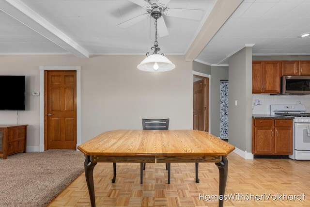 dining space featuring a ceiling fan, crown molding, baseboards, and beamed ceiling
