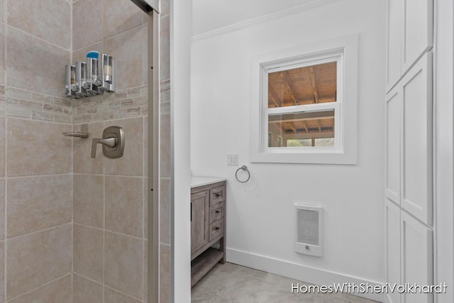 bathroom with a shower stall, ornamental molding, baseboards, heating unit, and vanity
