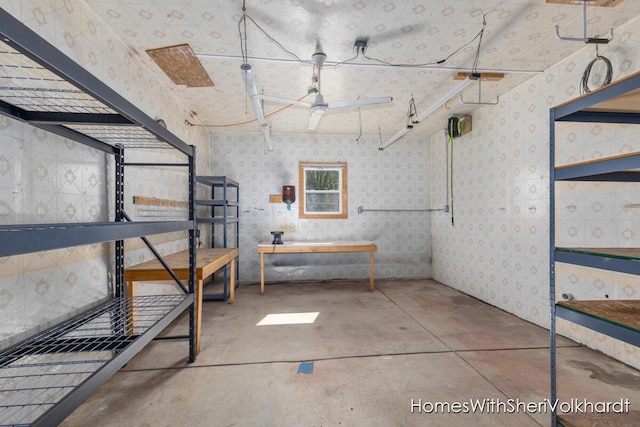 below grade area featuring wallpapered walls