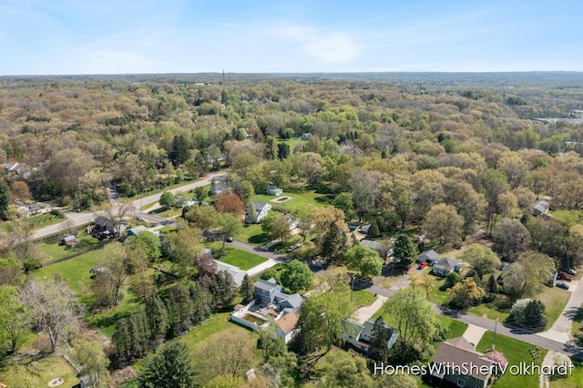 aerial overview of property's location with a heavily wooded area