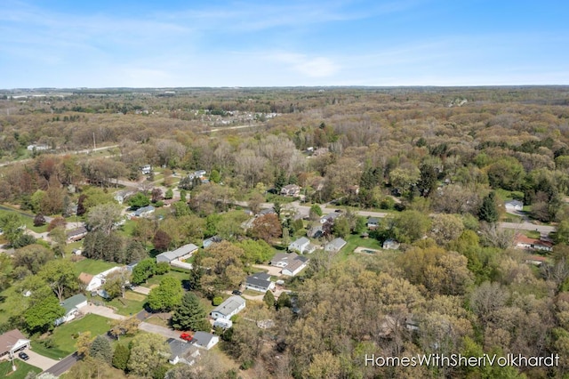 aerial overview of property's location with a heavily wooded area