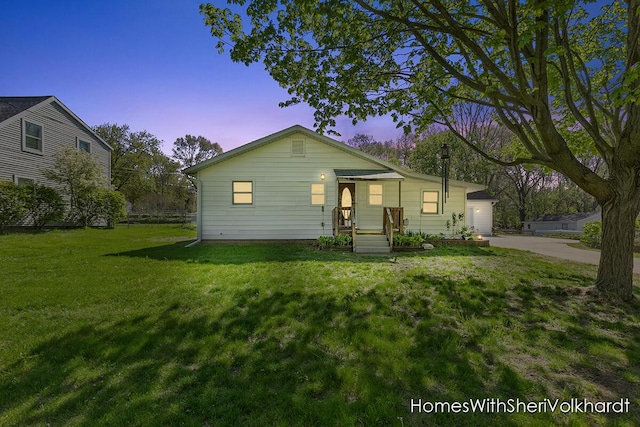 view of front facade with a front yard, driveway, and a garage