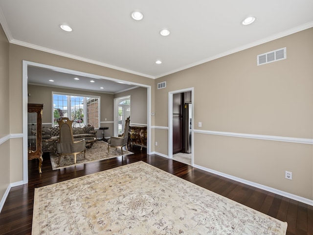 interior space featuring wood finished floors, crown molding, baseboards, and recessed lighting