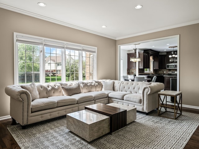 living room featuring recessed lighting, crown molding, baseboards, dark wood-style flooring, and a chandelier