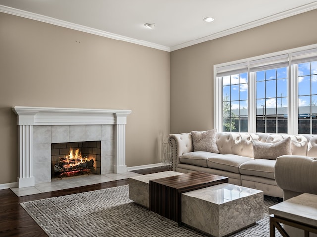 living area with a fireplace, wood finished floors, crown molding, baseboards, and recessed lighting