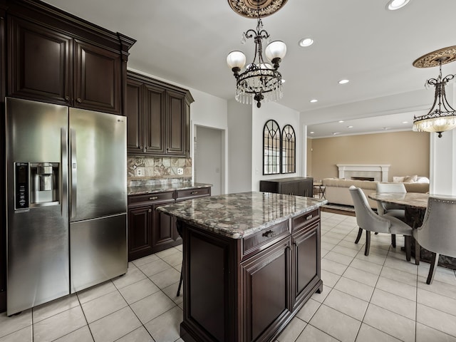 kitchen featuring stainless steel fridge, tasteful backsplash, light tile patterned flooring, pendant lighting, and recessed lighting