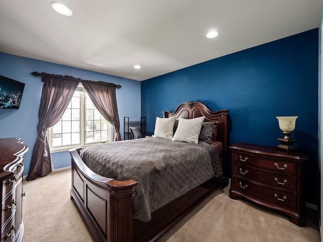 bedroom with recessed lighting, light carpet, and baseboards