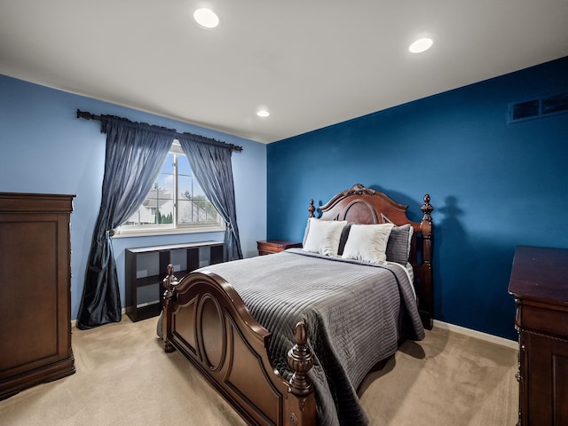 bedroom featuring light colored carpet, recessed lighting, and baseboards