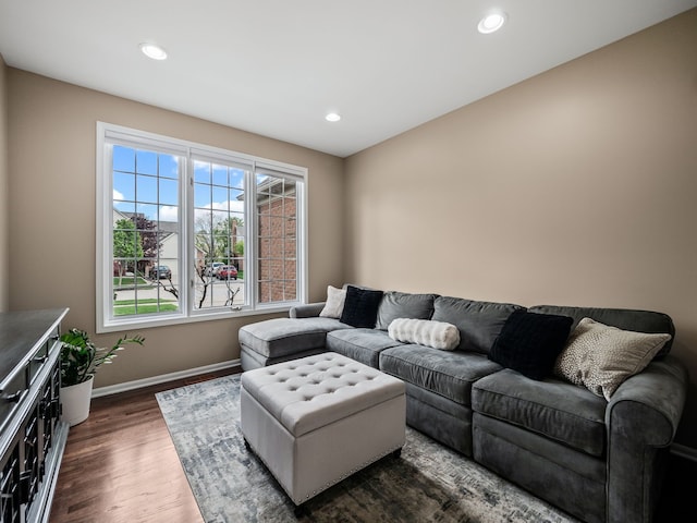 living room featuring dark wood-type flooring, baseboards, and recessed lighting