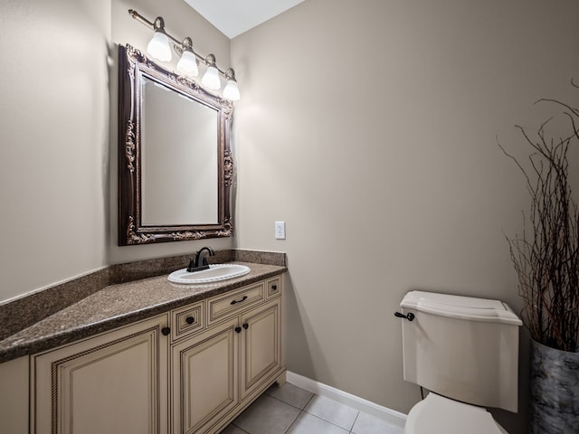 bathroom featuring tile patterned floors, toilet, vanity, and baseboards