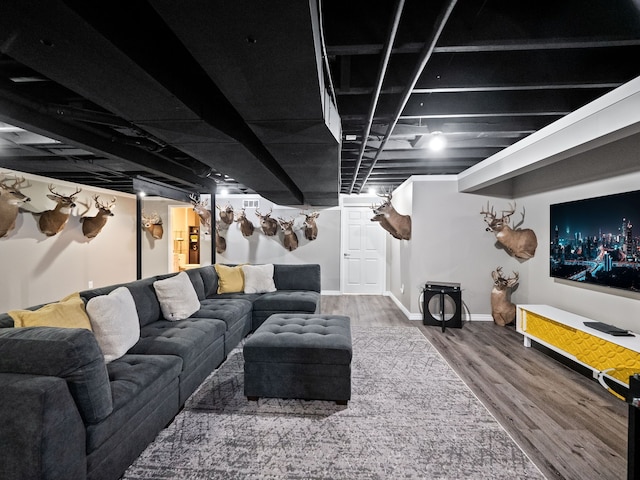 living area featuring wood finished floors and baseboards