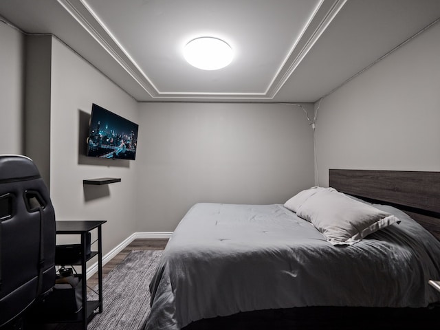 bedroom featuring wood finished floors and baseboards