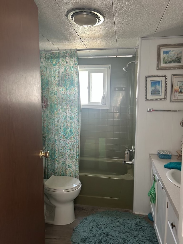 bathroom with shower / bath combination with curtain, toilet, and vanity