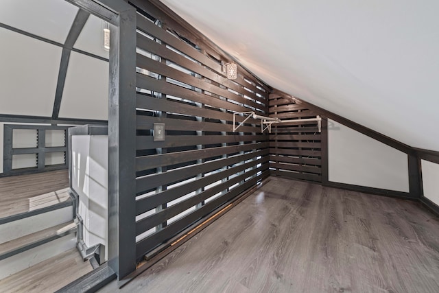 additional living space featuring wood finished floors