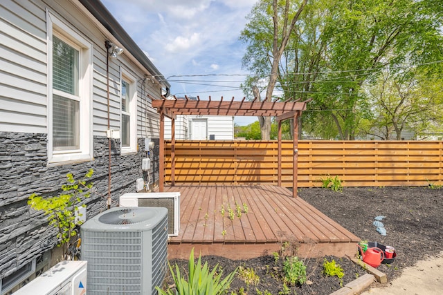 deck featuring central AC unit, a pergola, and a fenced backyard