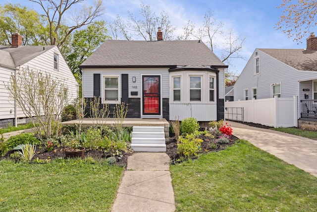 view of front of home featuring a chimney and concrete driveway