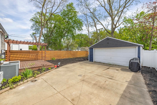 detached garage featuring central AC and fence