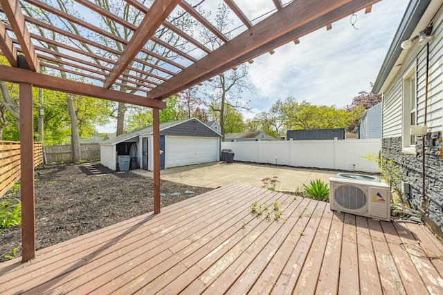 wooden terrace with a detached garage, ac unit, a fenced backyard, an outdoor structure, and a pergola