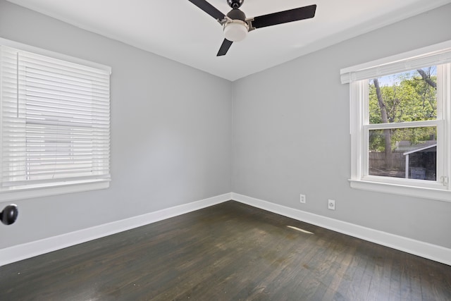 spare room featuring dark wood-type flooring, baseboards, and ceiling fan