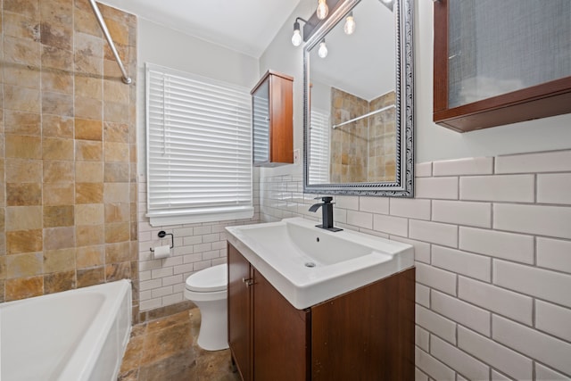 full bathroom featuring tile walls, toilet, vanity, and stone finish flooring